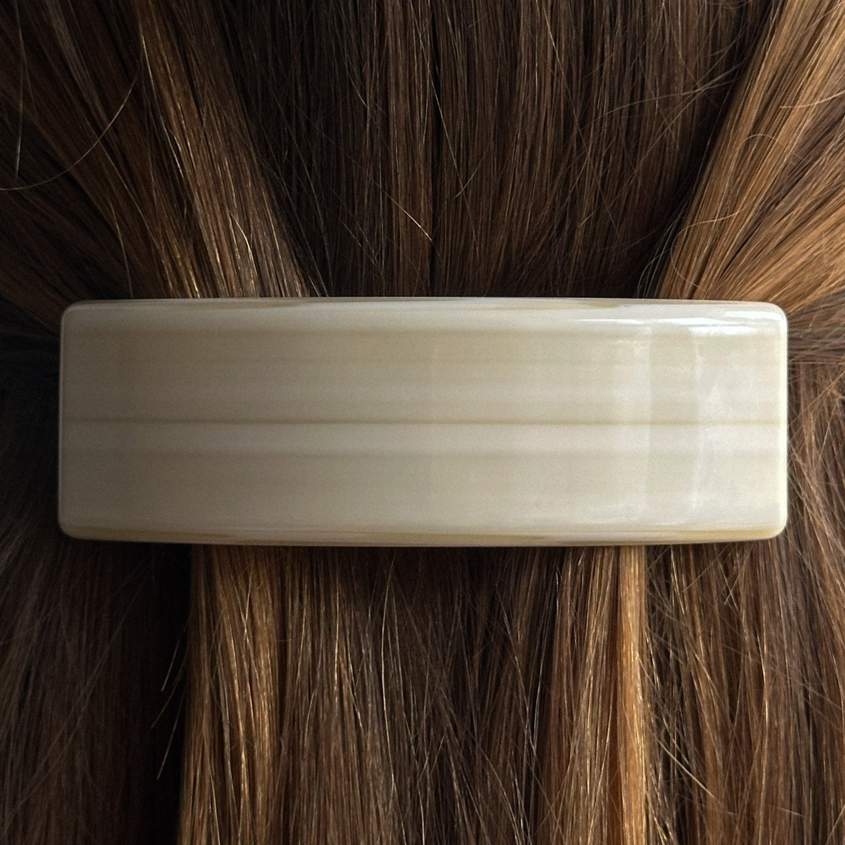 Rome Barrette in cream acetate, clipped into brown hair with caramel highlights at the nape, by Pico Copenhagen